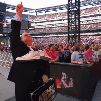 A Man In A Suit Is Holding A Briefcase That Says Money Bank On It GIF