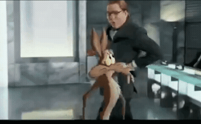 A Man In A Suit Is Holding A Cartoon Rabbit In His Arms In A Room . GIF