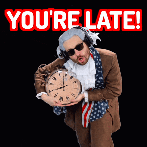 A Man In A Suit Is Holding A Clock With The Words You 'Re Late Behind Him GIF