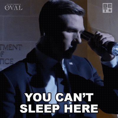 A Man In A Suit Is Holding A Flashlight And Says You Can T Sleep Here GIF