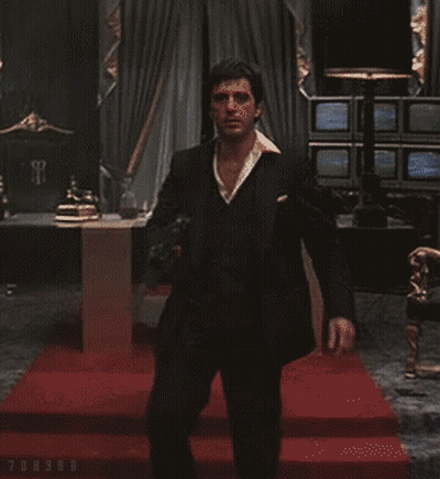 A Man In A Suit Is Holding A Gun In A Room With A Red Carpet And The Word Onsro On The Bottom Right GIF