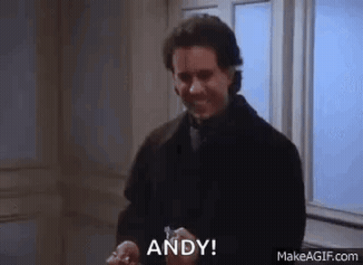 A Man In A Suit Is Holding A Key In His Hand And Saying `` Andy '' . GIF