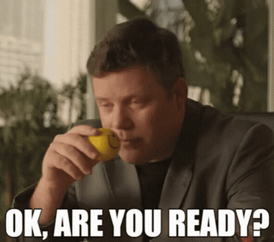 A Man In A Suit Is Holding A Lemon In His Mouth With The Words Ok Are You Ready Below Him GIF
