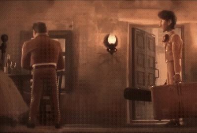 A Man In A Suit Is Holding A Light While Standing Next To A Woman GIF