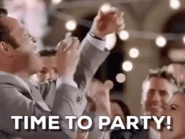 A Man In A Suit Is Holding A Microphone In Front Of A Crowd Of People And Says `` Time To Party '' . GIF