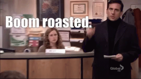 A Man In A Suit Is Holding A Piece Of Paper And Says Boom Roasted . GIF