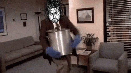 A Man In A Suit Is Holding A Pot In A Living Room . GIF