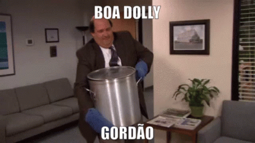 A Man In A Suit Is Holding A Pot With The Words Boa Doliy Gordao Written On It GIF