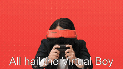 A Man In A Suit Is Holding A Video Game Controller And Says All Hail The Virtual Boy GIF