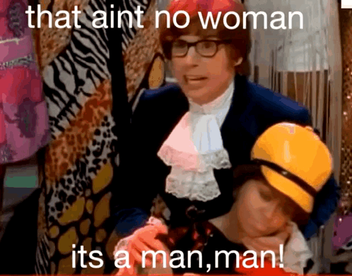 A Man In A Suit Is Holding A Woman And Says That Ain T No Woman It 'S A Man , Man GIF