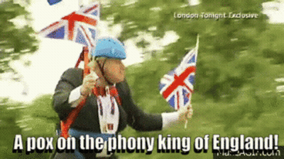 A Man In A Suit Is Holding British Flags And Says " A Pox On The Phony King Of England ! " GIF