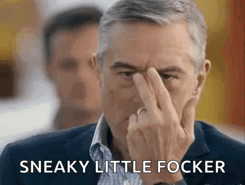 A Man In A Suit Is Holding His Finger To His Nose And Says Sneaky Little Focker . GIF