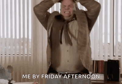 A Man In A Suit Is Holding His Head In His Hands And Screaming . GIF