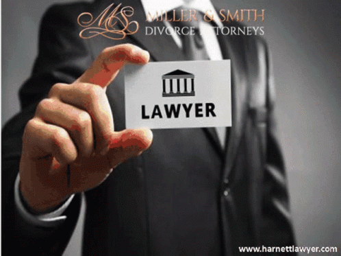 A Man In A Suit Is Holding Up A Business Card For A Lawyer GIF