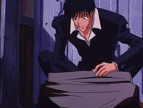 A Man In A Suit Is Kneeling Down In Front Of A Wooden Door GIF