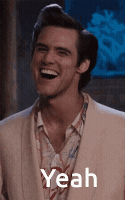 A Man In A Suit Is Laughing With The Word Yeah In The Corner GIF