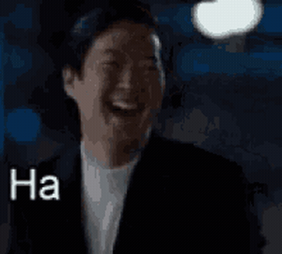 A Man In A Suit Is Laughing With The Words `` Ha Haaa '' Written Next To Him . GIF