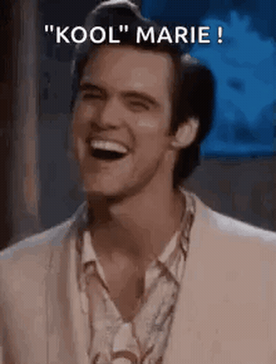 A Man In A Suit Is Laughing With The Words `` Kool '' Marie Written Above Him . GIF