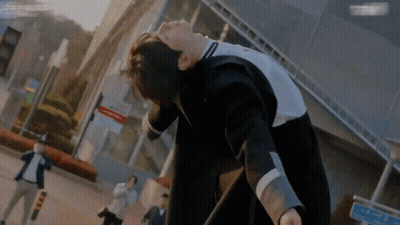 A Man In A Suit Is Laying On His Back In Front Of A Sign That Says ' A ' On It GIF