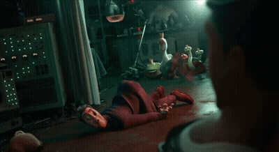 A Man In A Suit Is Looking At Another Man In A Dark Room GIF