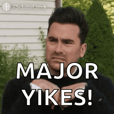 A Man In A Suit Is Making A Face And Says Major Yikes ! GIF
