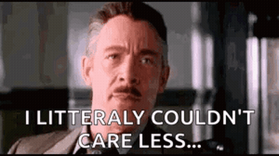 A Man In A Suit Is Making A Funny Face And Saying `` I Litterally Couldn 'T Care Less ... '' GIF
