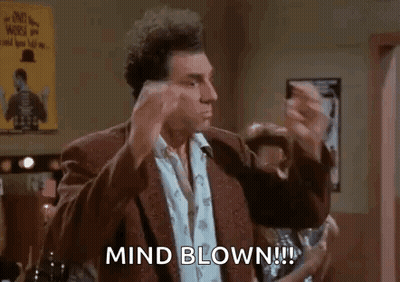 A Man In A Suit Is Making A Funny Face And Says `` Mind Blown ! '' GIF