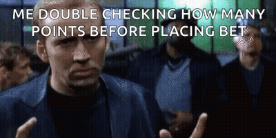 A Man In A Suit Is Making A Funny Face While Standing In Front Of A Crowd Of People . GIF