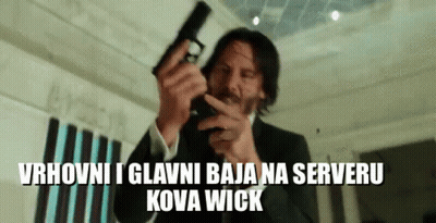 A Man In A Suit Is Pointing A Gun At The Camera With The Words Kova Wick Below Him . GIF