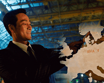 A Man In A Suit Is Pointing At A Map That Says Germa Y On It GIF
