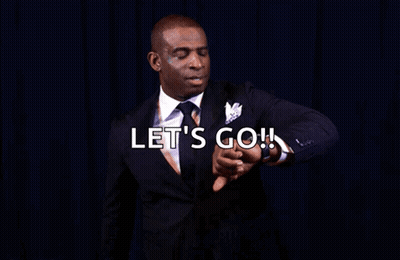 A Man In A Suit Is Pointing At His Watch With The Words Let 'S Go You Know What Time It Is GIF