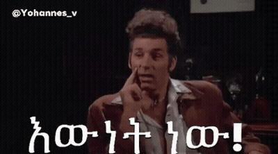 A Man In A Suit Is Pointing At Something In A Dark Room With The Words Yohannes_v Written On The Bottom GIF