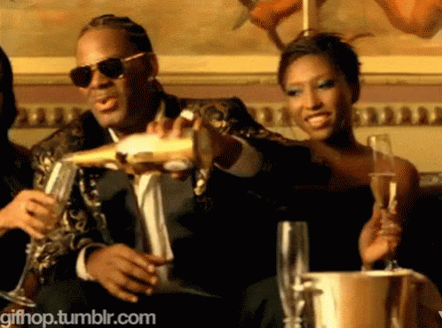A Man In A Suit Is Pouring Champagne Into A Glass GIF