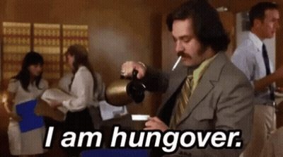 A Man In A Suit Is Pouring Coffee Into A Cup While Smoking A Cigarette And Saying `` I Am Hungover '' GIF
