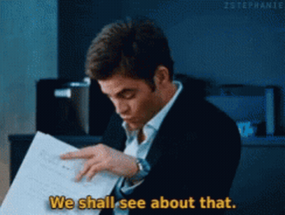 A Man In A Suit Is Reading A Piece Of Paper And Saying We Shall See About That GIF