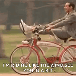 A Man In A Suit Is Riding A Bicycle With His Feet Up And A Quote . GIF