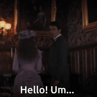 A Man In A Suit Is Saying Hello Um GIF