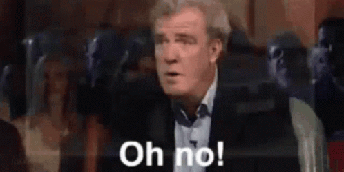 A Man In A Suit Is Saying Oh No . GIF