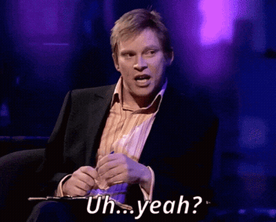 A Man In A Suit Is Saying Uh Yeah While Holding A Pen GIF