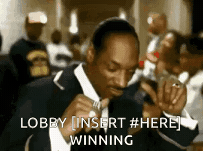 A Man In A Suit Is Singing Into A Microphone With The Words Lobby Insert # Here Winning Behind Him GIF