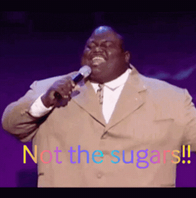 A Man In A Suit Is Singing Into A Microphone With The Words Not The Sugars Written On The Bottom GIF