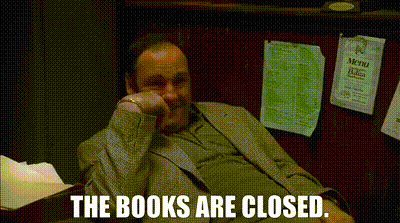A Man In A Suit Is Sitting At A Desk With His Hand On His Chin And The Words The Books Are Closed . GIF