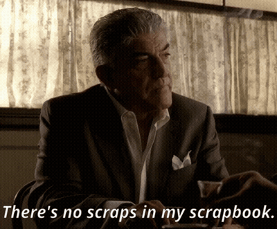 A Man In A Suit Is Sitting At A Table And Says There 'S No Scraps In My Scrapbook GIF