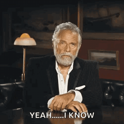 A Man In A Suit Is Sitting At A Table And Says " Yeah I Know " GIF