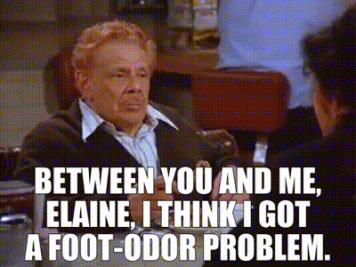 A Man In A Suit Is Sitting At A Table With A Woman And Says Between You And Me Elaine GIF
