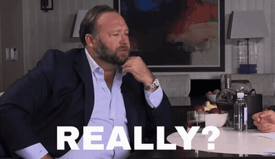 A Man In A Suit Is Sitting At A Table With The Word Really Written On The Table GIF