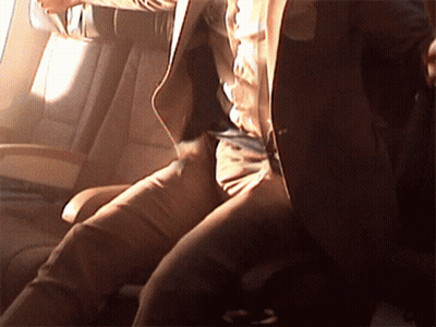 A Man In A Suit Is Sitting In A Car GIF