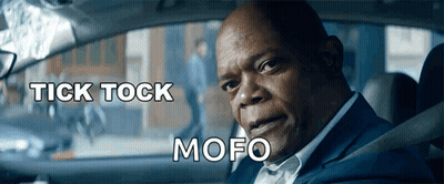 A Man In A Suit Is Sitting In A Car With The Words Tick Tock Mofo Below Him GIF