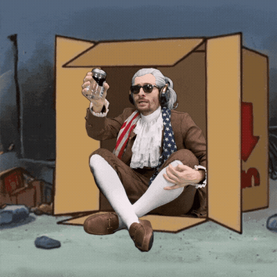 A Man In A Suit Is Sitting In A Cardboard Box Holding A Can Of Soda GIF