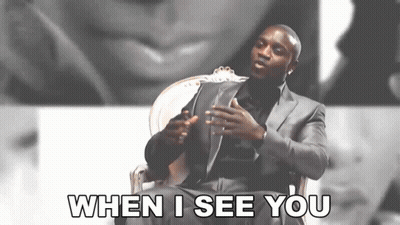 A Man In A Suit Is Sitting In A Chair And Saying When I See You GIF